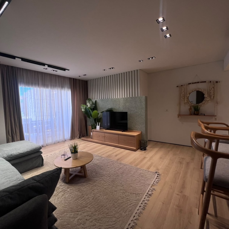 Living room with track lighting and striped curtains in Mesca cabana, Soma Bay